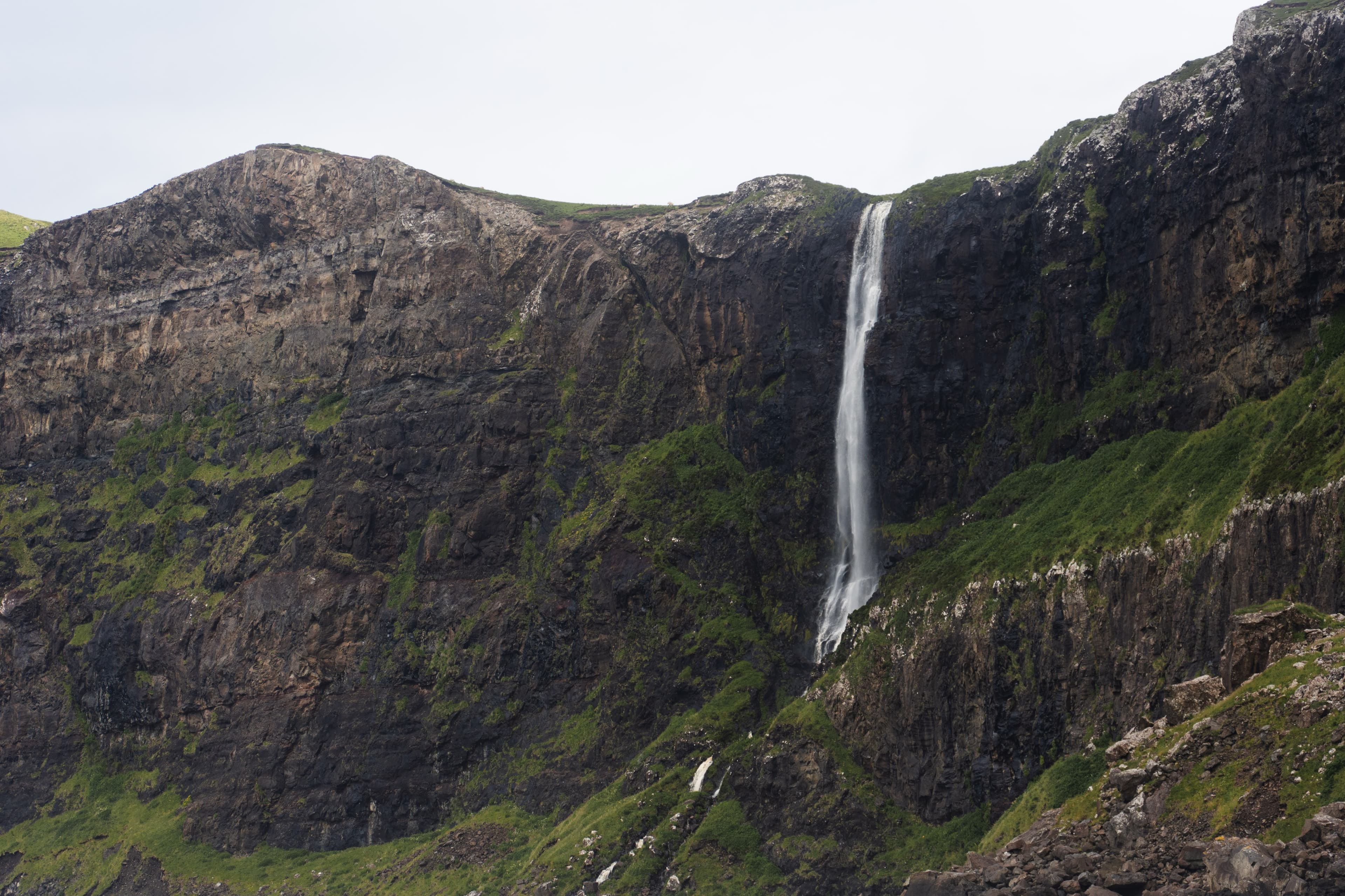 Waterfall cascading down a rocky cliff face, Skye, Scotland